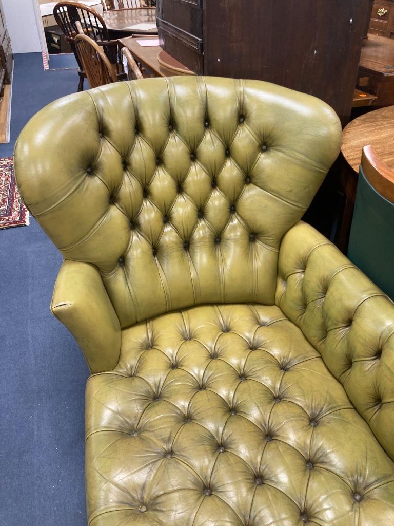 A Victorian style daybed upholstered in buttoned green leather, length 170cm, width 70cm, height 82cm